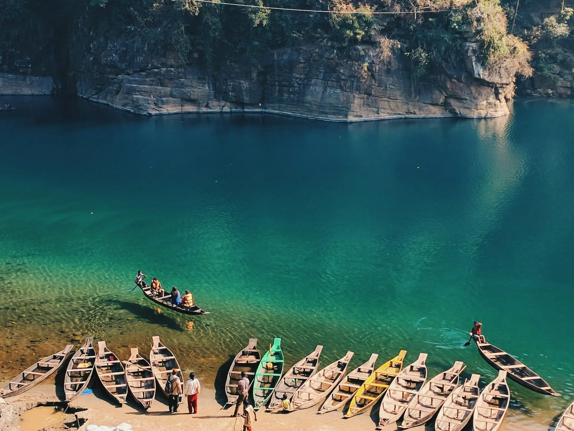 Boats pulled up on the stony bank of the Umngot River at Dawki