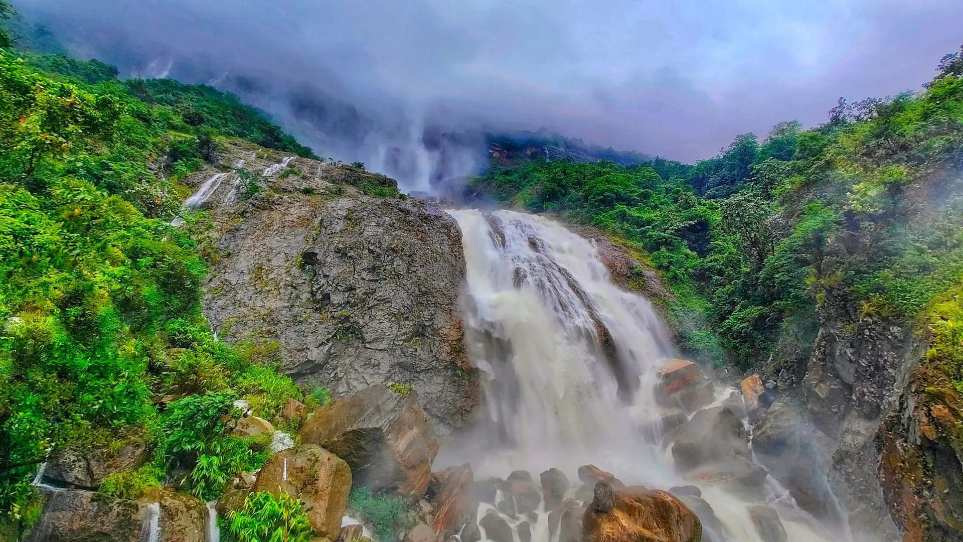 Kynrem Falls cascading through lush forest near Cherrapunji