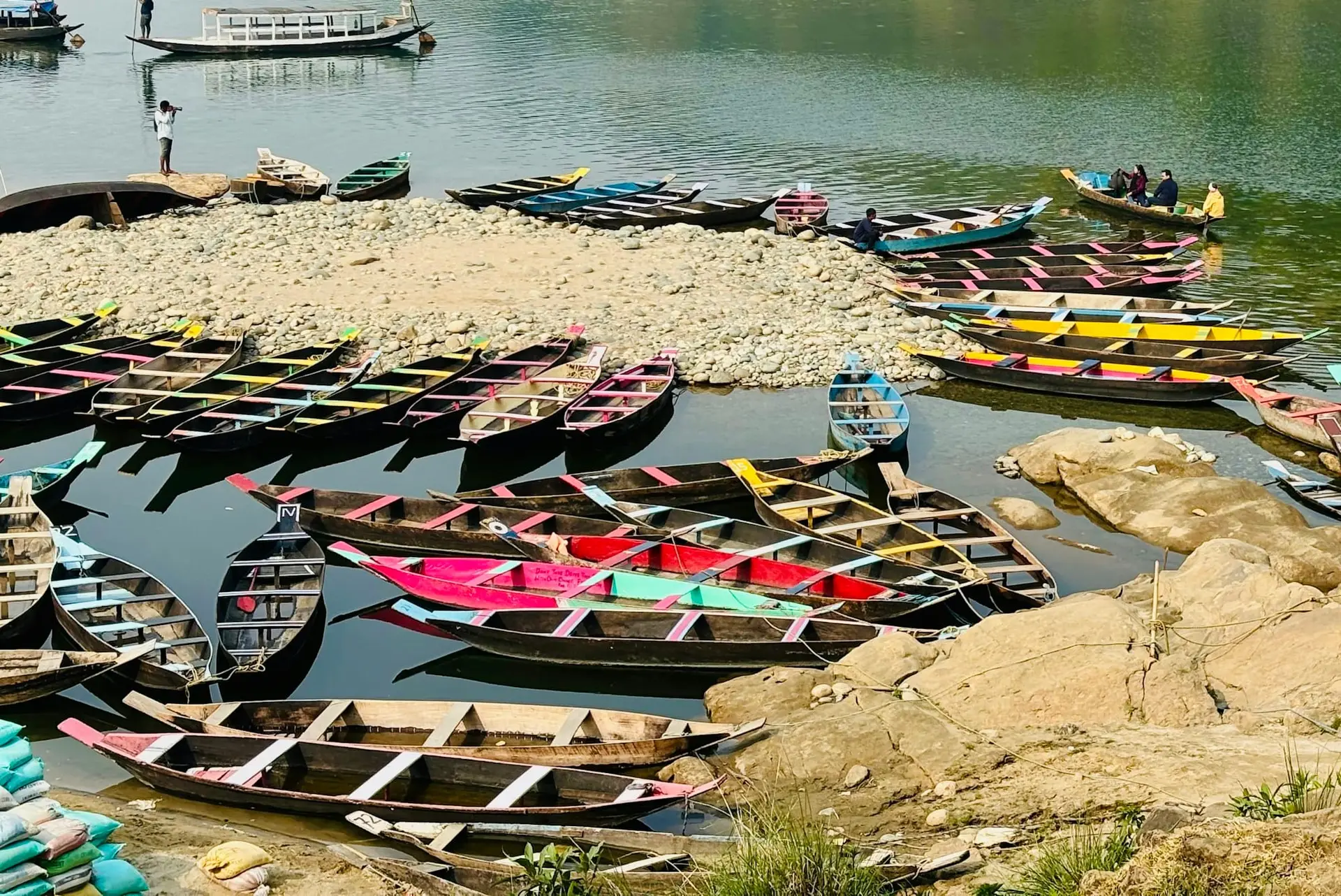 Colourful boats gathered at the Umngot River near the Dawki bridge