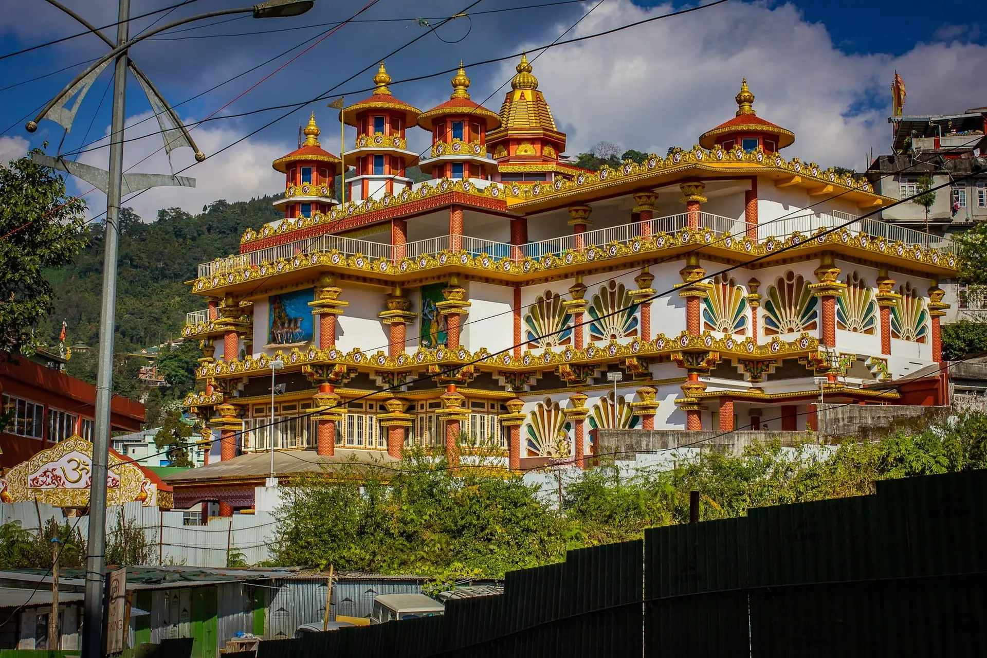 A richly painted Tibetan-style building with carved windows in Gangtok