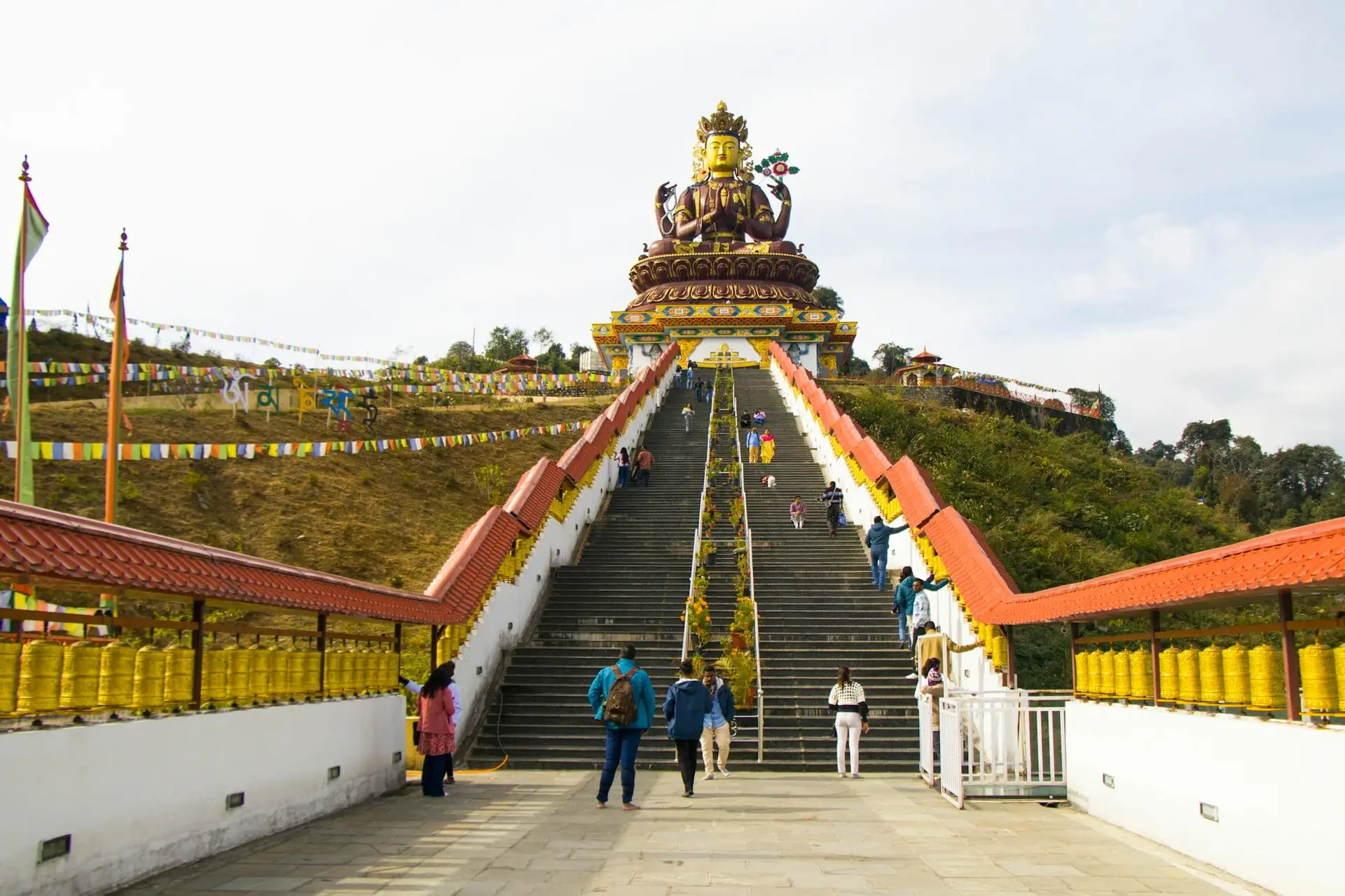 Visitors walking the skywalk towards the Chenrezig statue in Pelling